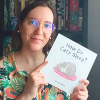 Patricia Caldeira holding her book, 'How Do Cats Sleep'